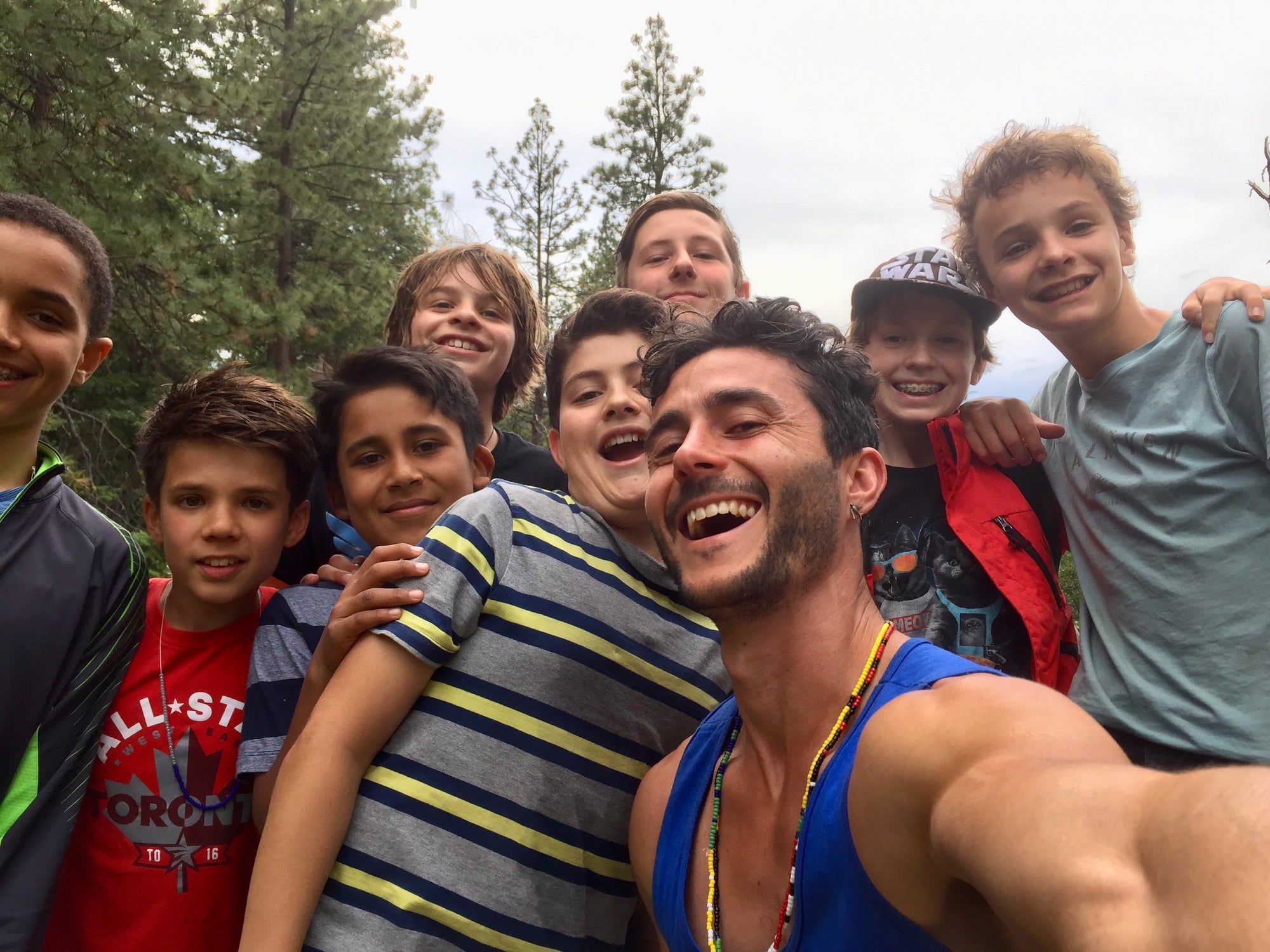 Diverse group of friends enjoying a campfire gathering in the forest