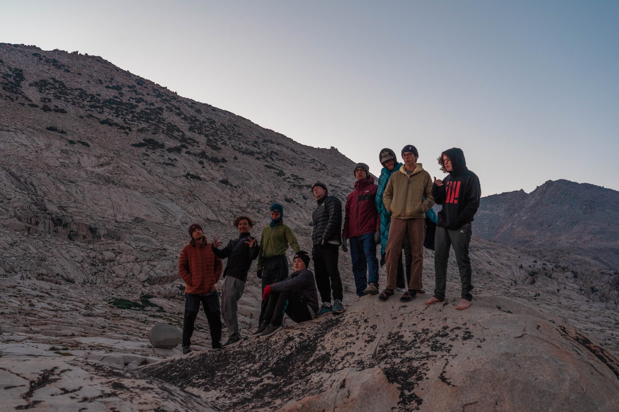Two backpackers trekking along a scenic rocky mountain path