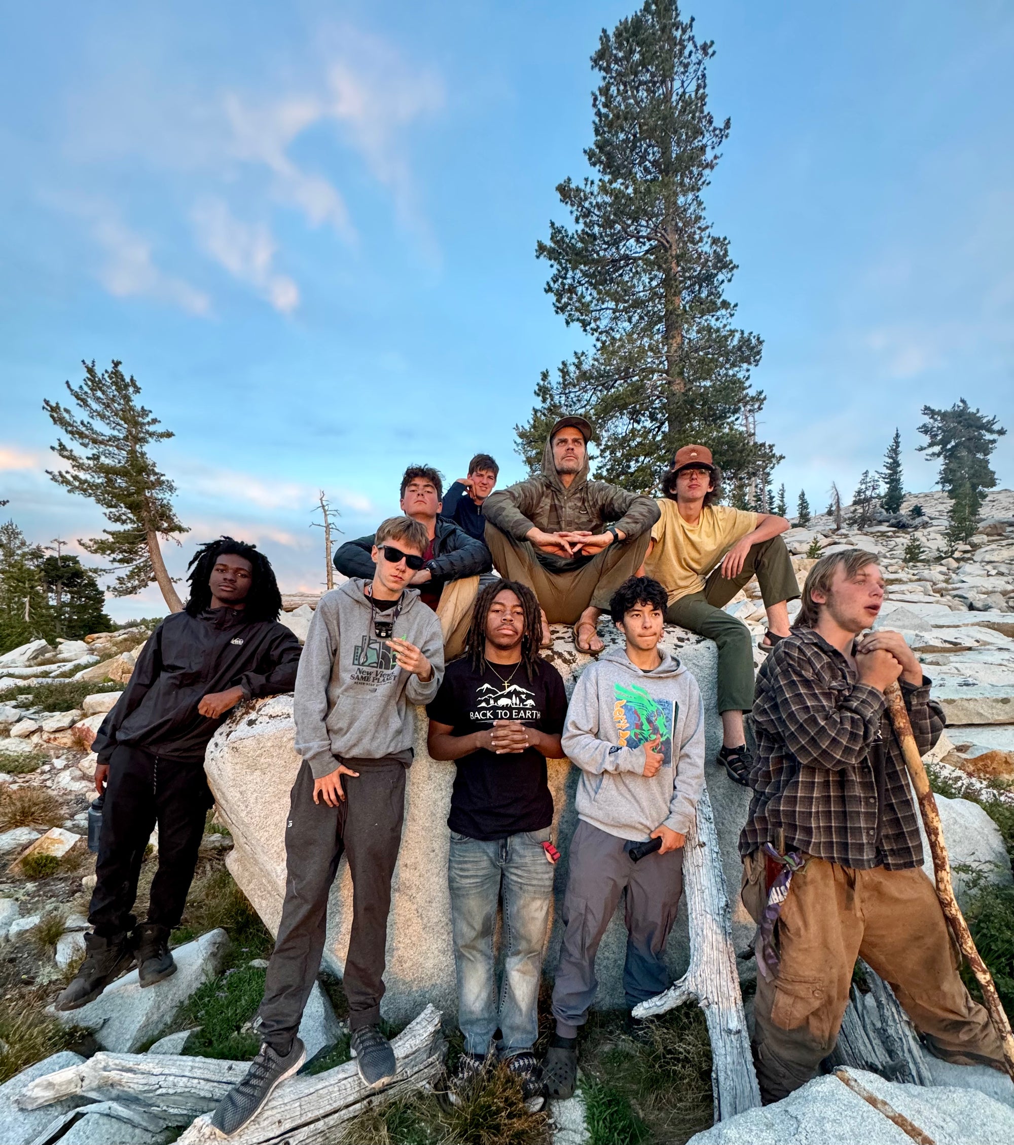 A diverse group of kids sitting in a circle outdoors