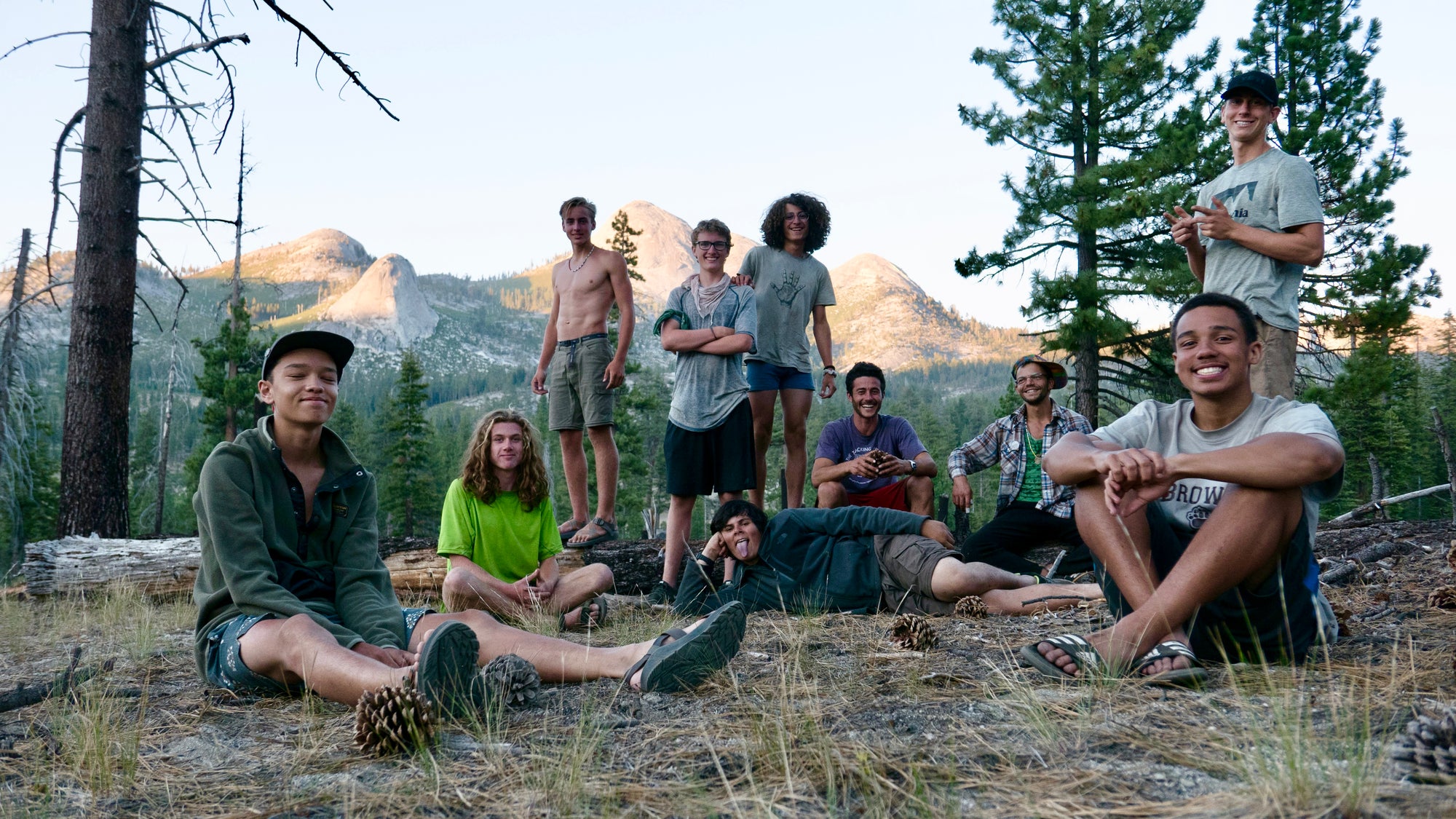 Diverse group of friends smiling and hiking through a lush forest path
