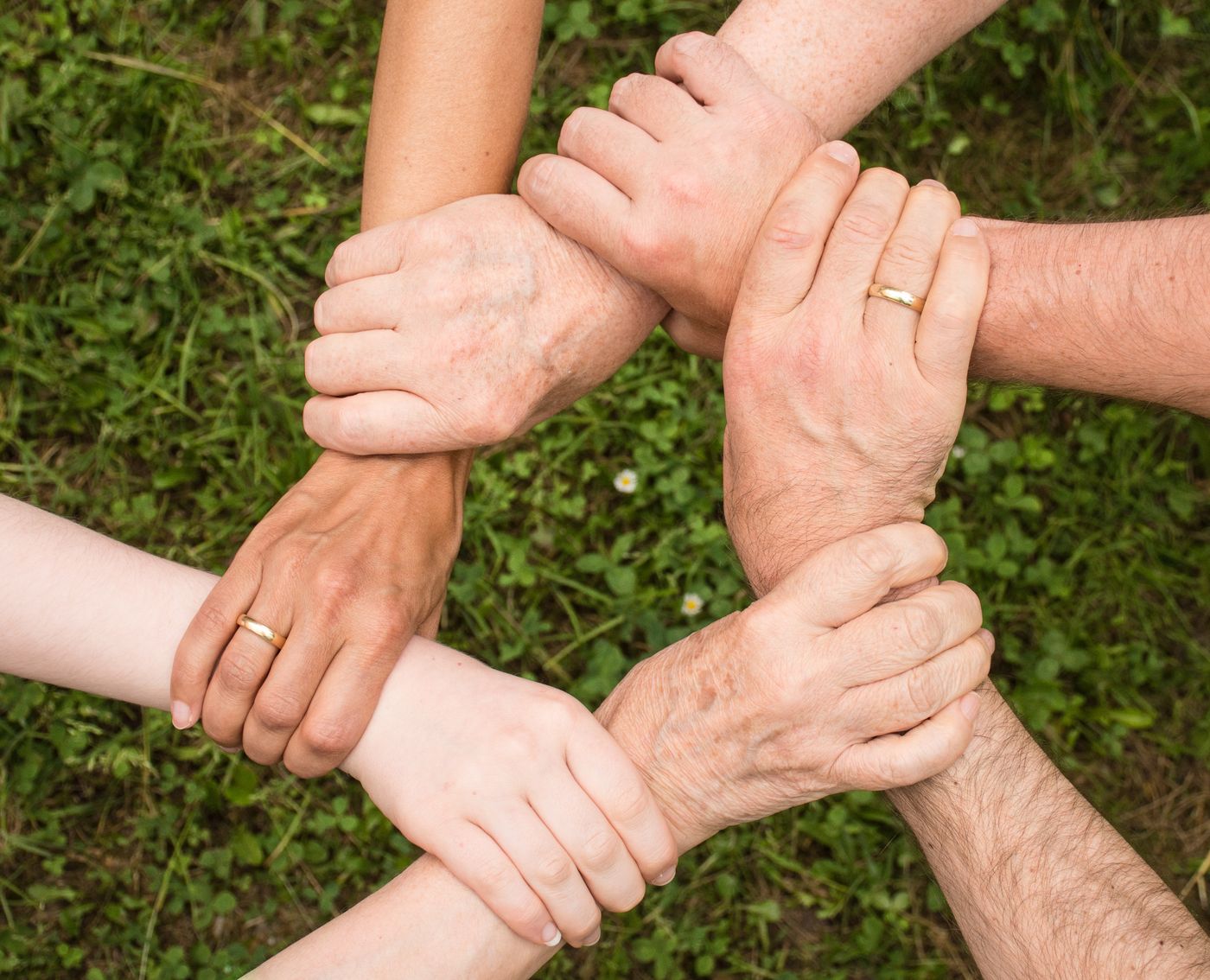 Diverse hands joined together in a circle