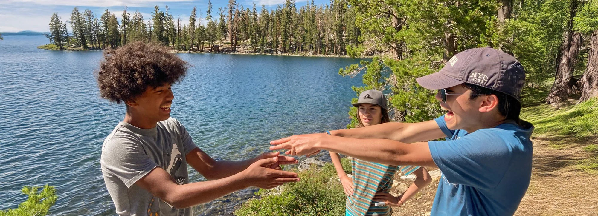 Two young people reaching out to each other outdoors