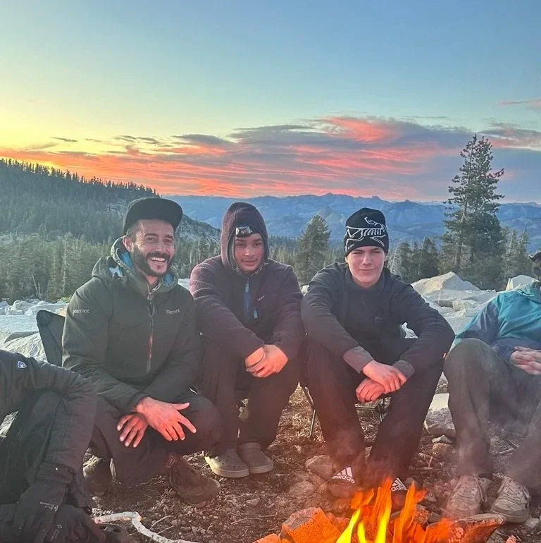 Group around a campfire at sunset