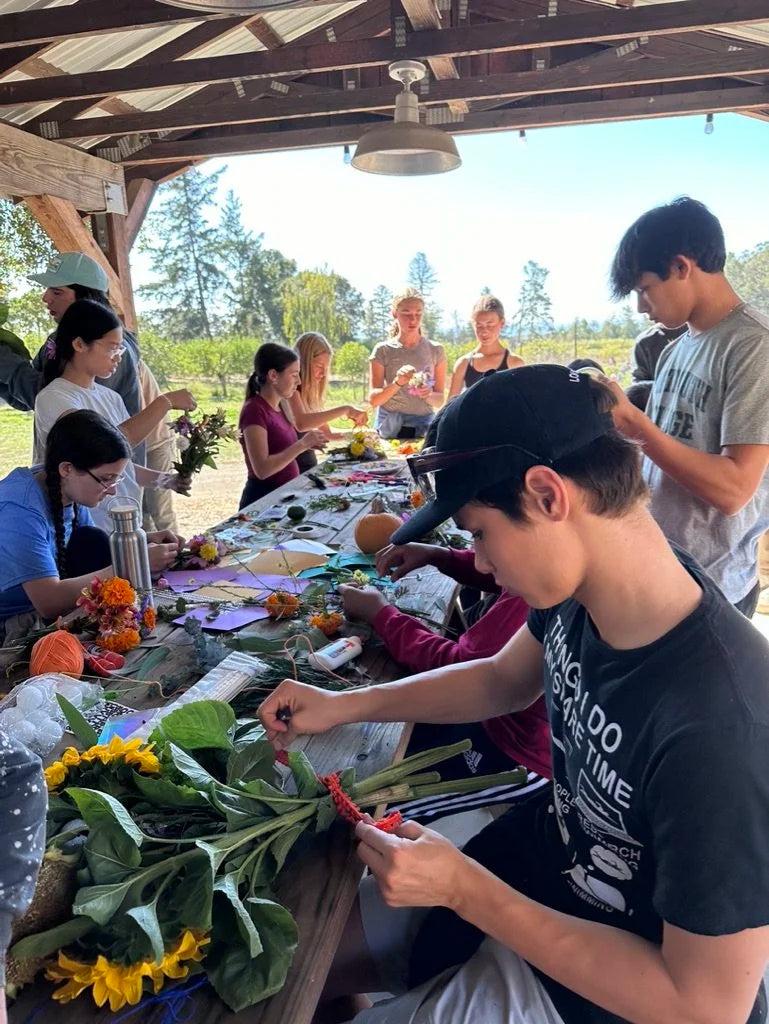 Group making flower arrangements outdoors